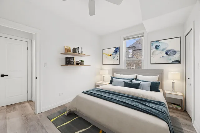 a bedroom with a bed and painting on the wall