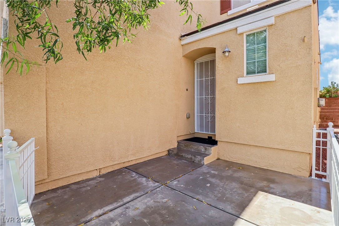 7331 Carrot Ridge Street Las Vegas, NV 89139 - Photo 2 of 28 Property entrance with a patio area, stucco siding