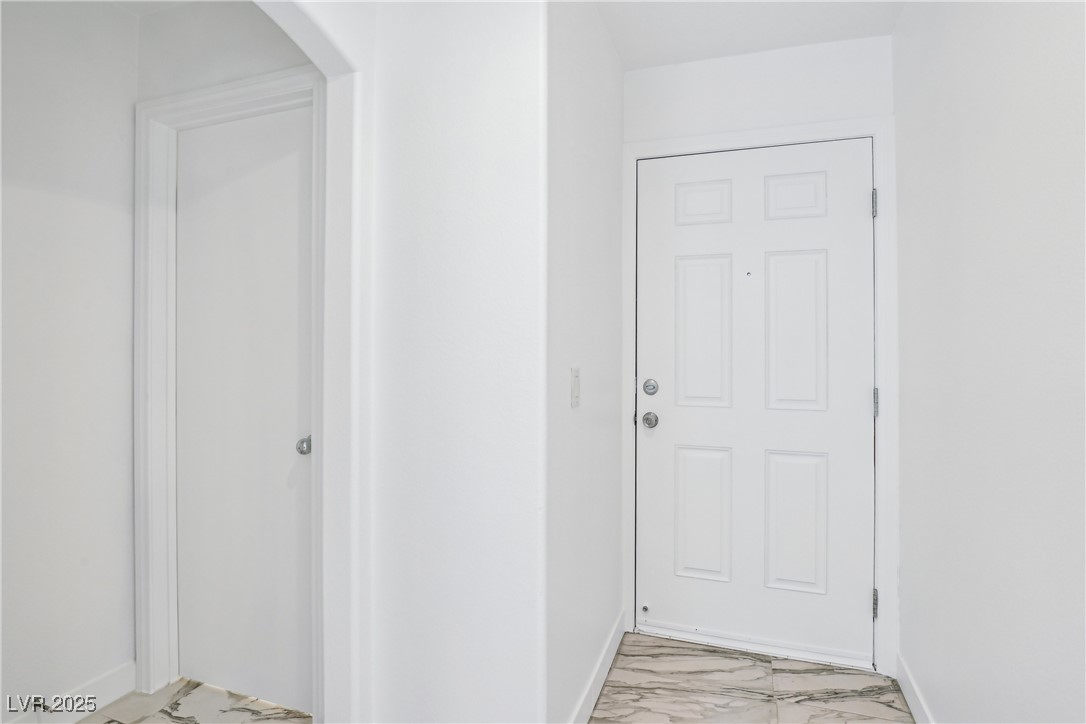 7331 Carrot Ridge Street Las Vegas, NV 89139 - Photo 3 of 28 Hallway with light marble finish floors, baseboard