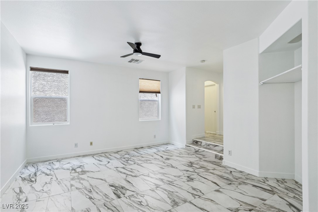 7331 Carrot Ridge Street Las Vegas, NV 89139 - Photo 4 of 28 Living room featuring marble look tiles, arched wa