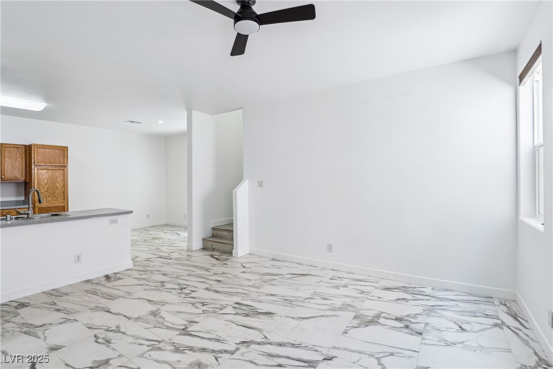 7331 Carrot Ridge Street Las Vegas, NV 89139 - Photo 5 of 28 Unfurnished living room featuring a sink, a ceilin