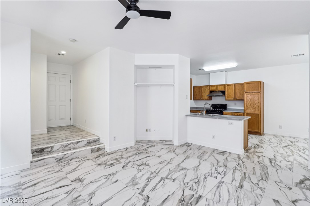 7331 Carrot Ridge Street Las Vegas, NV 89139 - Photo 6 of 28 Unfurnished living room with ceiling fan, light ma