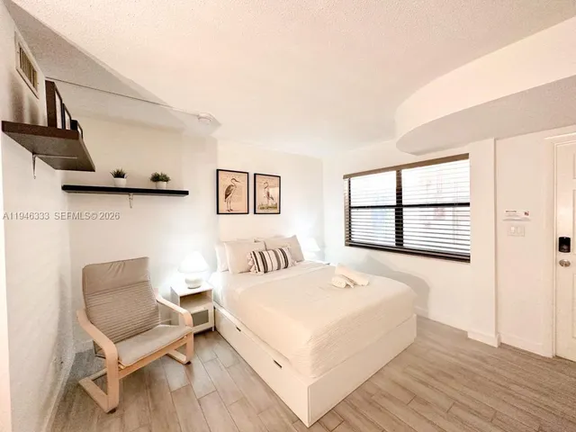 a bedroom with a bed and a chair