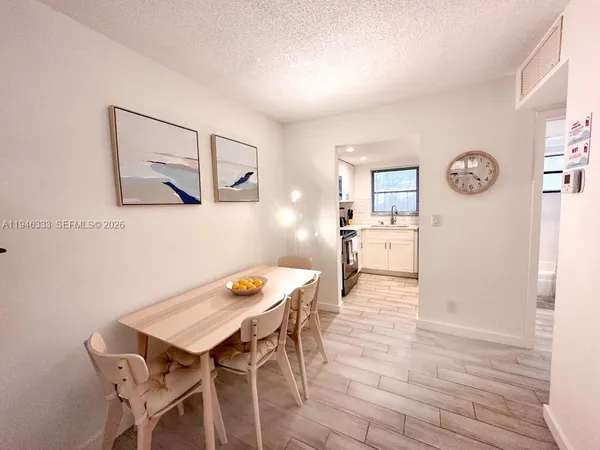 a view of a dining room with furniture and wooden floor