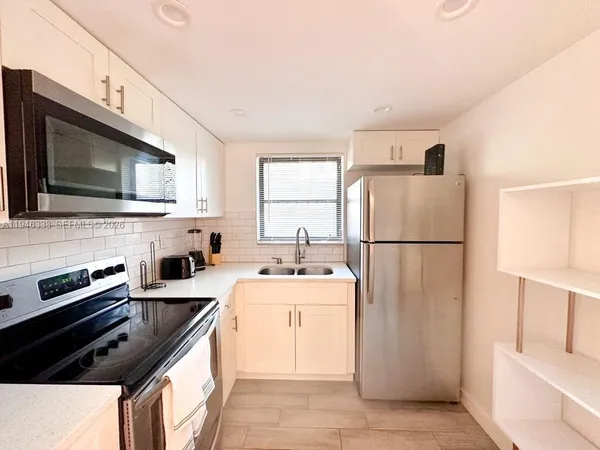 a kitchen with a refrigerator stove and microwave