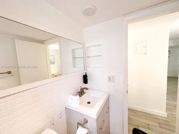 a bathroom with a sink mirror and vanity