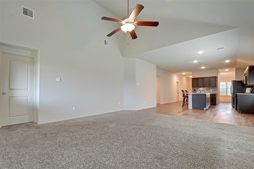1415 Rodeo Cattle Lane Houston, TX 77049 - Photo 11 of 18 a view of an empty room with a kitchen