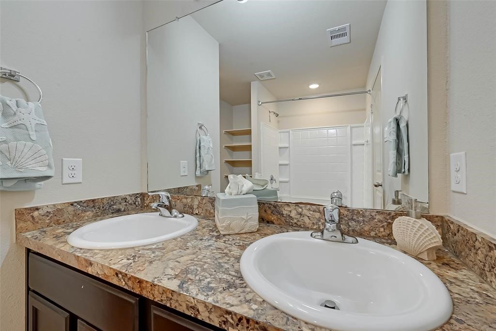 1415 Rodeo Cattle Lane Houston, TX 77049 - Photo 13 of 18 a bathroom with a granite countertop sink and a mirror