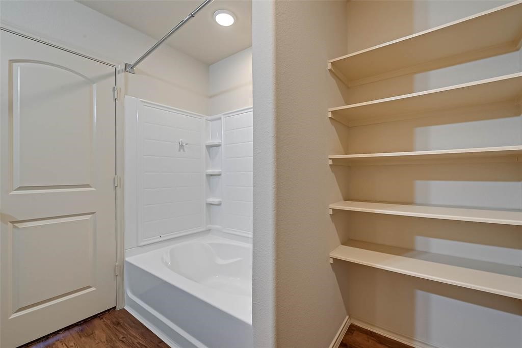 1415 Rodeo Cattle Lane Houston, TX 77049 - Photo 14 of 18 a bathroom with a tub and shower