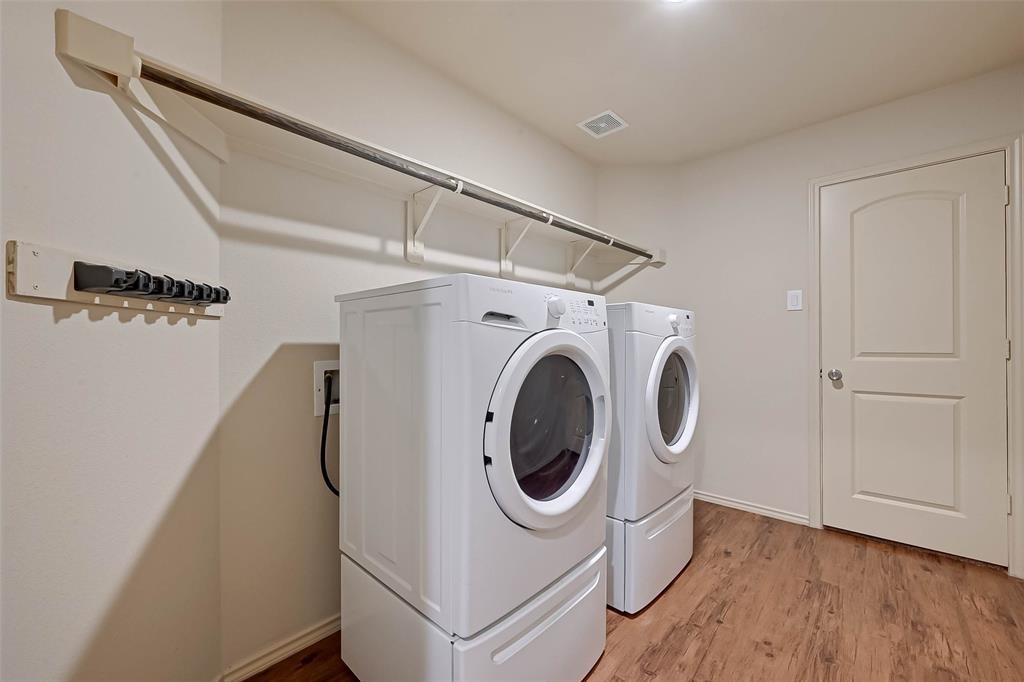 1415 Rodeo Cattle Lane Houston, TX 77049 - Photo 15 of 18 a utility room with dryer and washer