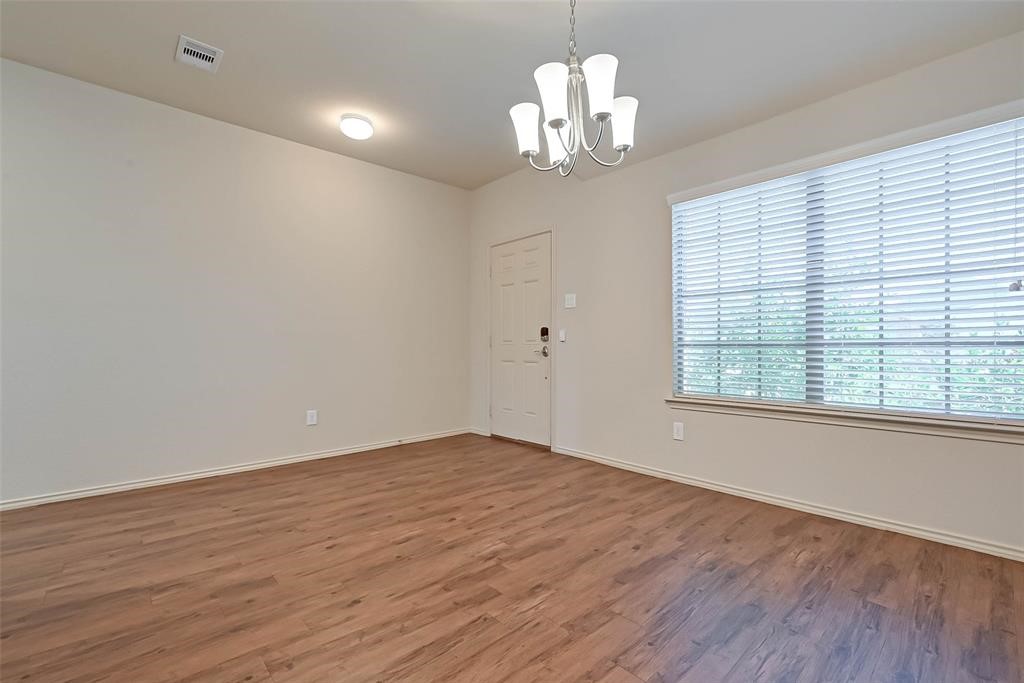 1415 Rodeo Cattle Lane Houston, TX 77049 - Photo 4 of 18 wooden floor in an empty room with a window