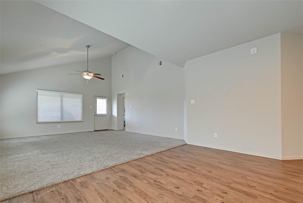 1415 Rodeo Cattle Lane Houston, TX 77049 - Photo 9 of 18 an empty room with wooden floor and windows