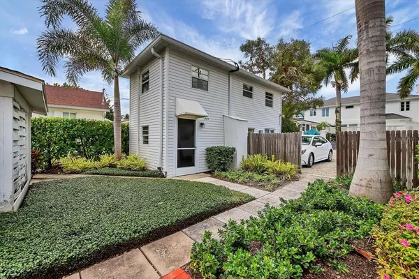 a front view of a house with a yard and outdoor seating