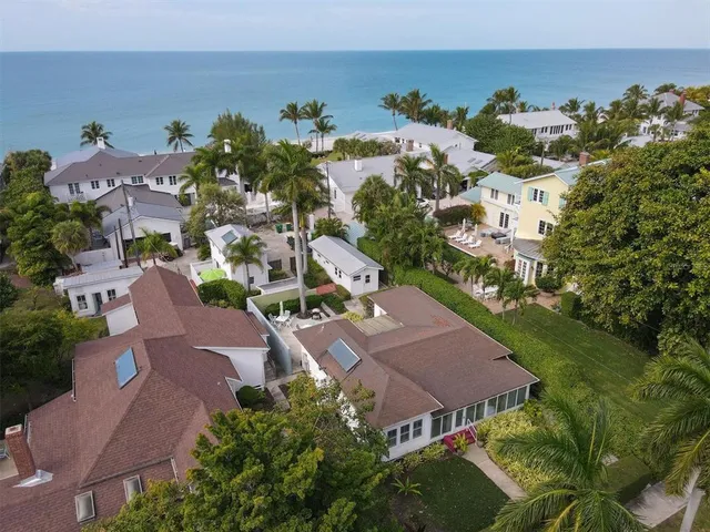 an aerial view of multiple houses with yard