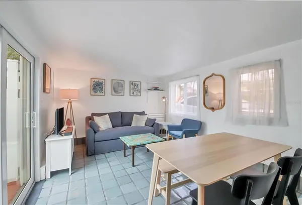 a living room with furniture a mirror and a table