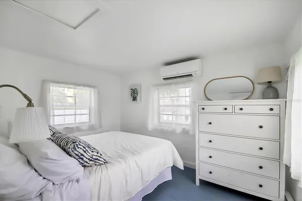 a bedroom with a bed and a dresser