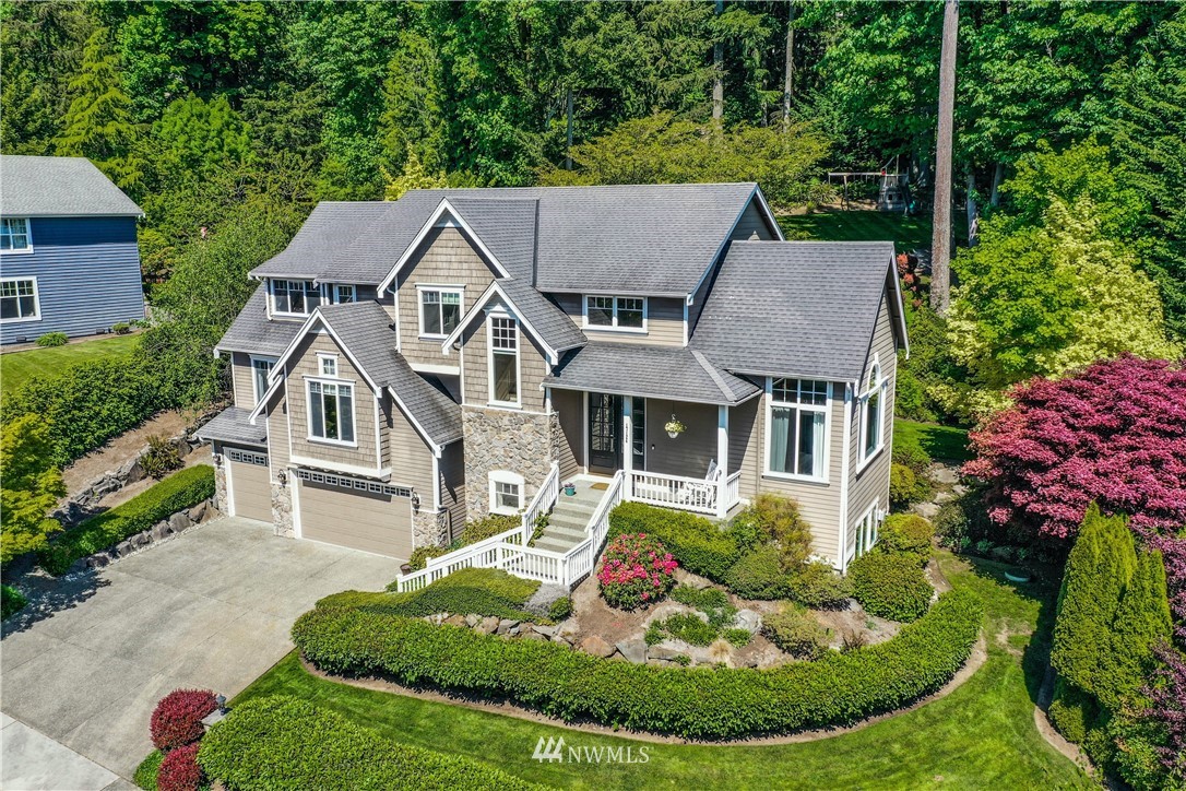 an aerial view of a house with yard