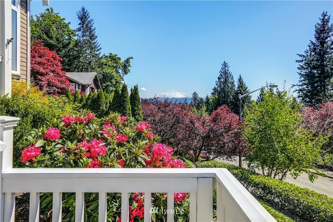 17124 Southeast 100th Street Renton, WA 98059 - Photo 2 of 40 a view of a potted flower in a balcony with wooden fence