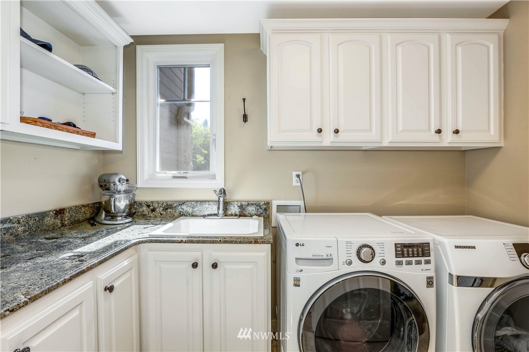 17124 Southeast 100th Street Renton, WA 98059 - Photo 15 of 40 a view of a kitchen with sink washer and dryer