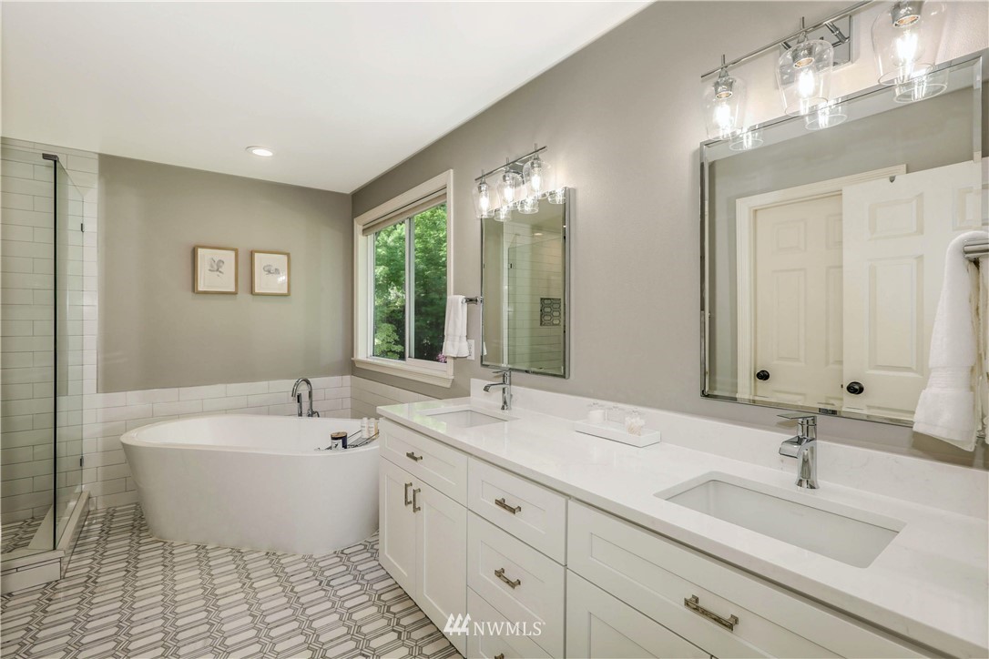 17124 Southeast 100th Street Renton, WA 98059 - Photo 19 of 40 a spacious bathroom with a double vanity sink mirror and bathtub