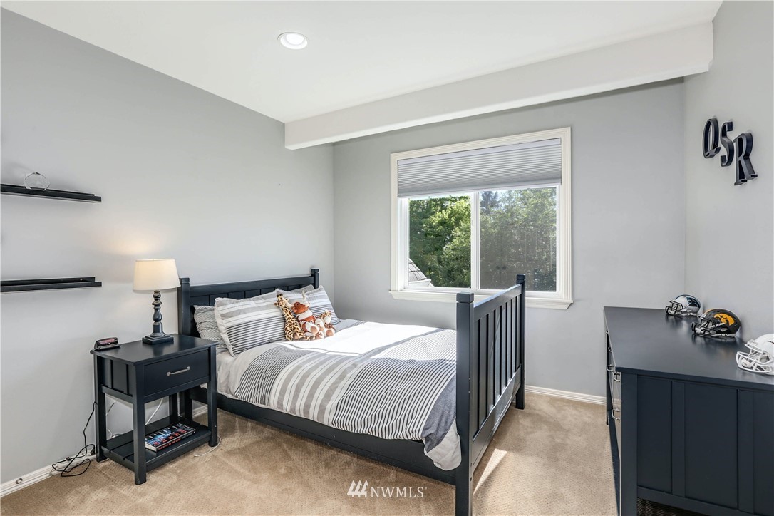 17124 Southeast 100th Street Renton, WA 98059 - Photo 22 of 40 a bedroom with a bed and a dresser next to a window