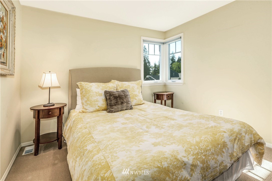 17124 Southeast 100th Street Renton, WA 98059 - Photo 23 of 40 a large bed sitting in a bedroom next to a window