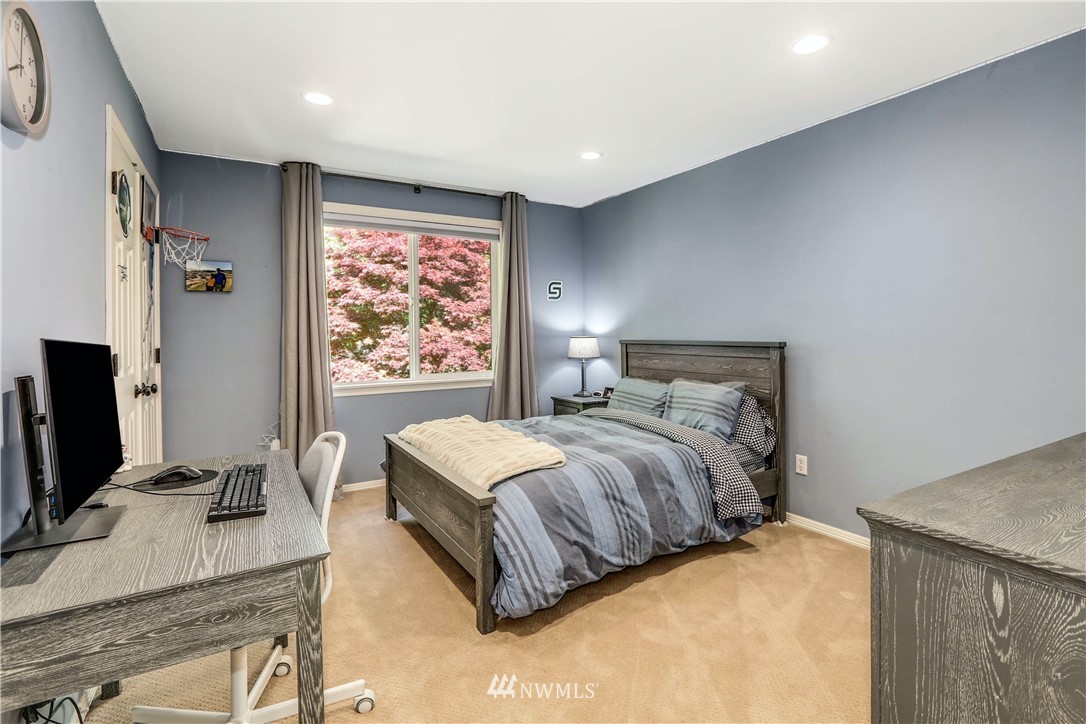 17124 Southeast 100th Street Renton, WA 98059 - Photo 24 of 40 a bedroom with a bed and a flat screen tv