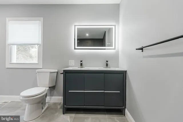 a bathroom with a toilet and a sink