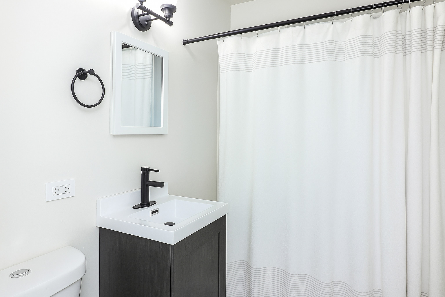 3210 Madison Avenue Brookfield, IL 60513 - Photo 13 of 27 a bathroom with a sink a mirror and a shower curtain