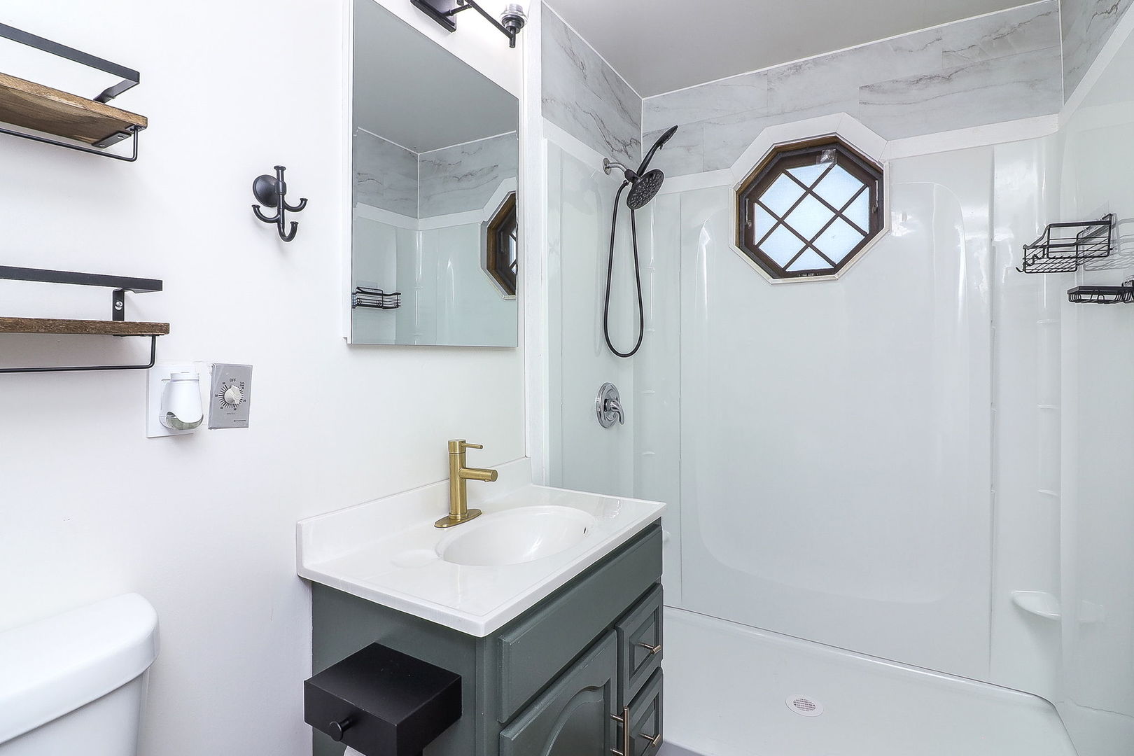 3210 Madison Avenue Brookfield, IL 60513 - Photo 15 of 27 a bathroom with a sink a mirror and a shower