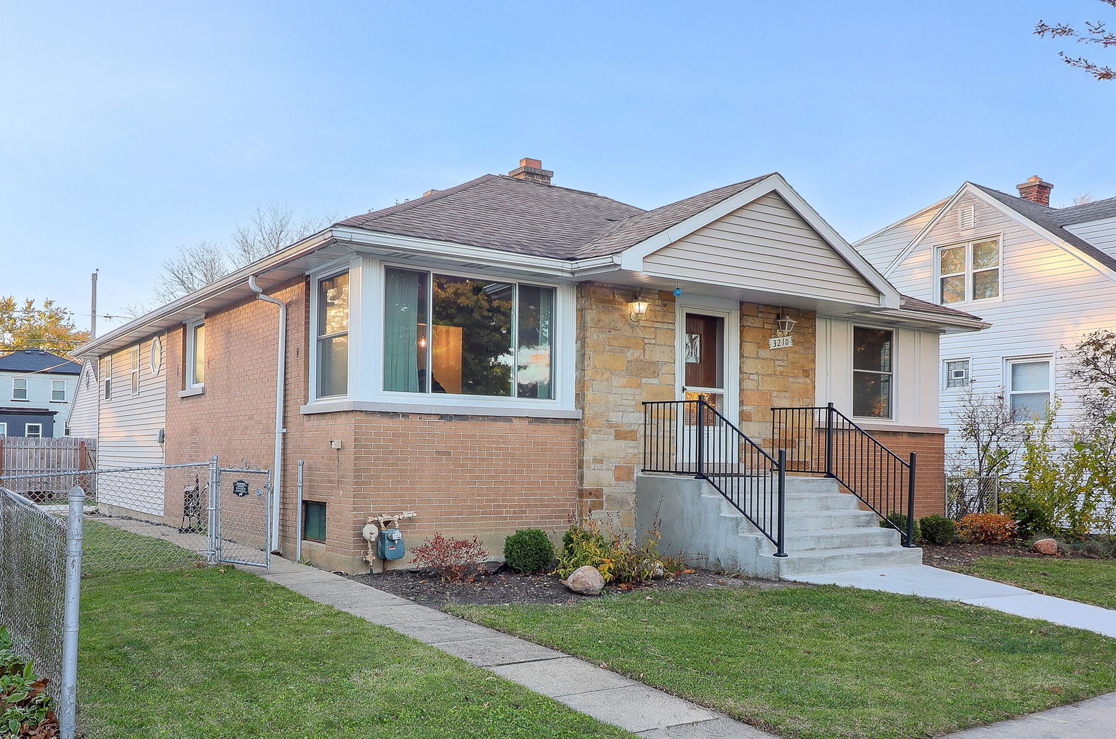 3210 Madison Avenue Brookfield, IL 60513 - Photo 2 of 27 a front view of a house with a yard and fence