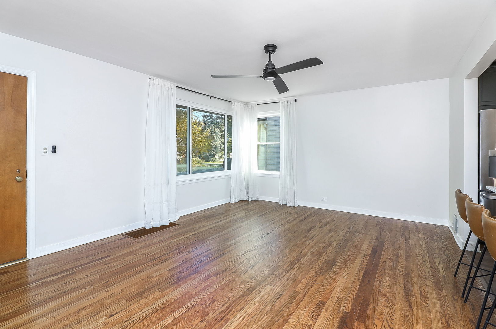 3210 Madison Avenue Brookfield, IL 60513 - Photo 3 of 27 a view of empty room with wooden floor and fan