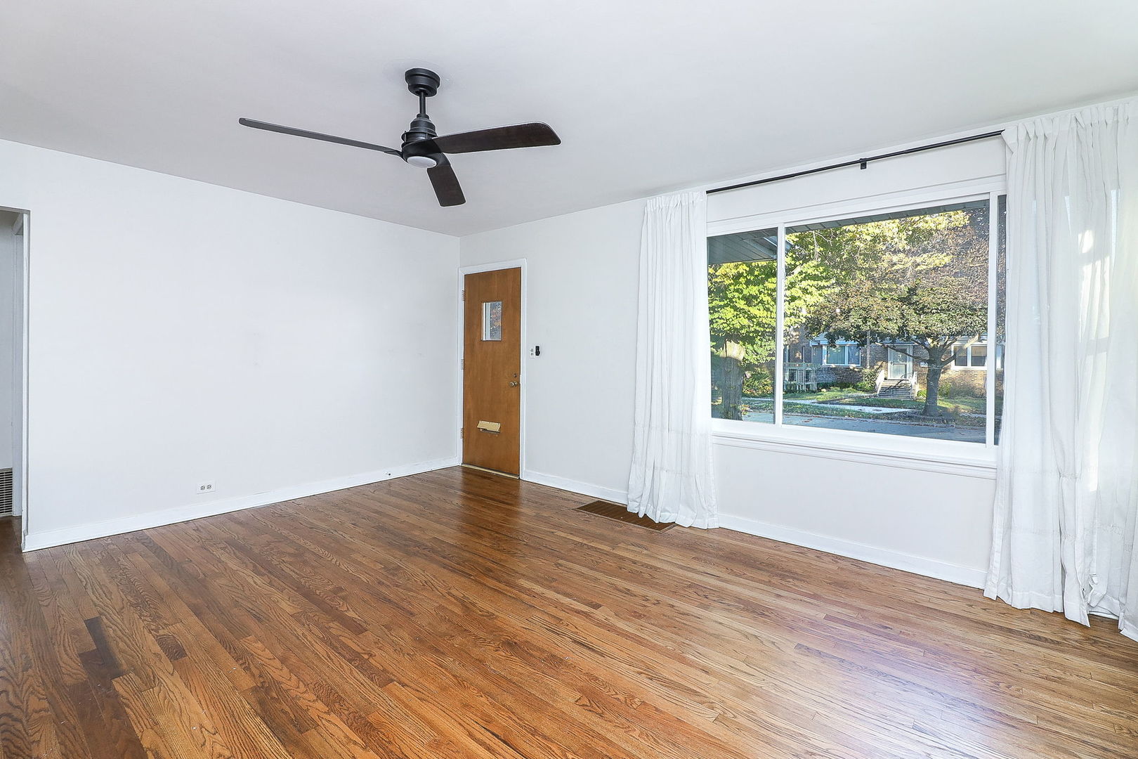 3210 Madison Avenue Brookfield, IL 60513 - Photo 4 of 27 a view of empty room with wooden floor and fan