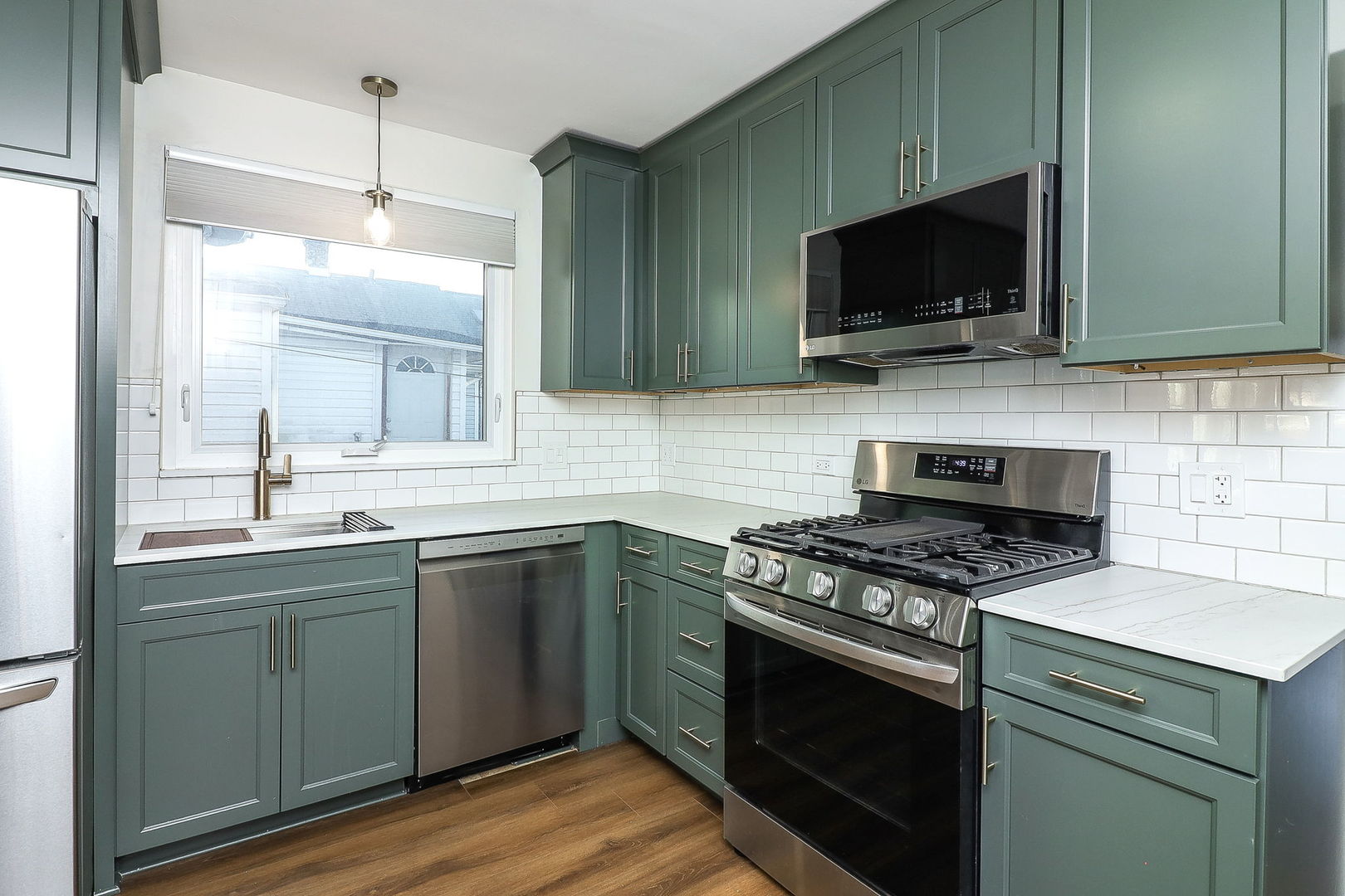 3210 Madison Avenue Brookfield, IL 60513 - Photo 7 of 27 a kitchen with a sink stove and microwave