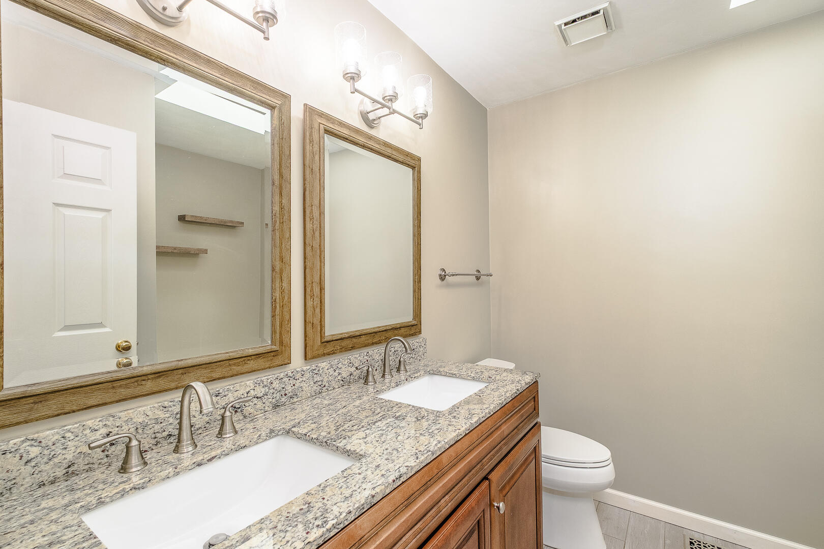 5443 Setter Road Roanoke, VA 24012 - Photo 15 of 42 a bathroom with a granite countertop sink a toilet and a mirror