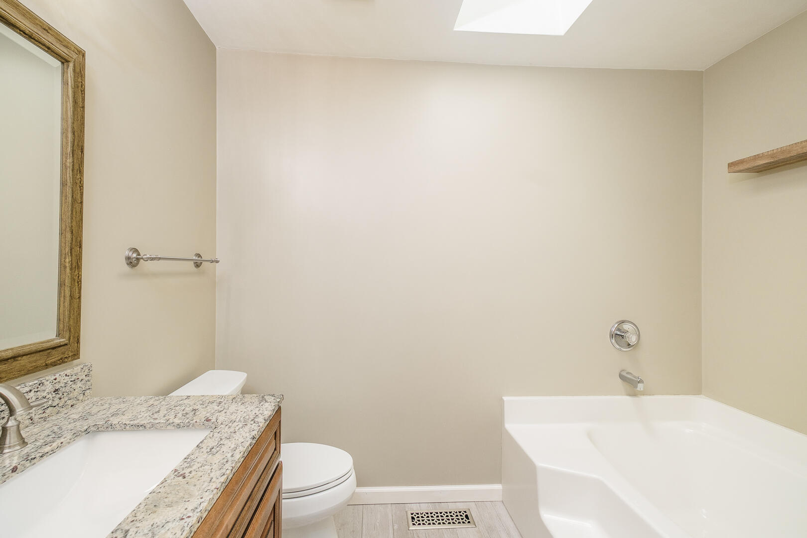5443 Setter Road Roanoke, VA 24012 - Photo 16 of 42 a bathroom with a granite countertop sink a toilet and a mirror