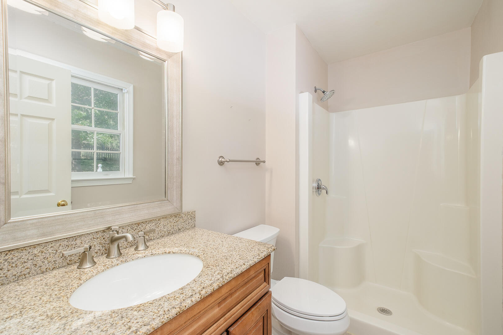 5443 Setter Road Roanoke, VA 24012 - Photo 23 of 42 a bathroom with a granite countertop sink toilet a mirror and shower