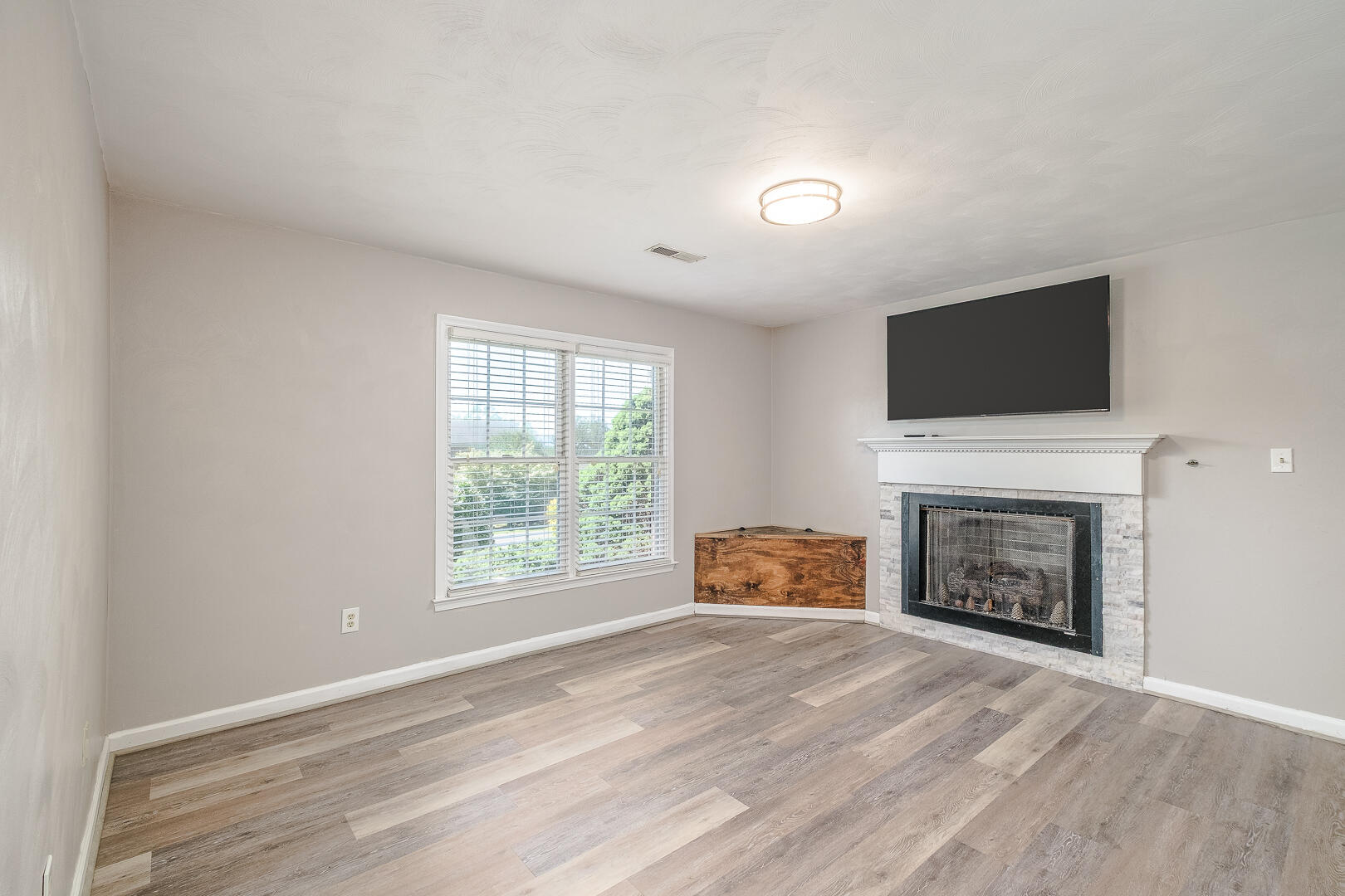 5443 Setter Road Roanoke, VA 24012 - Photo 25 of 42 a view of an empty room with a fireplace and a window
