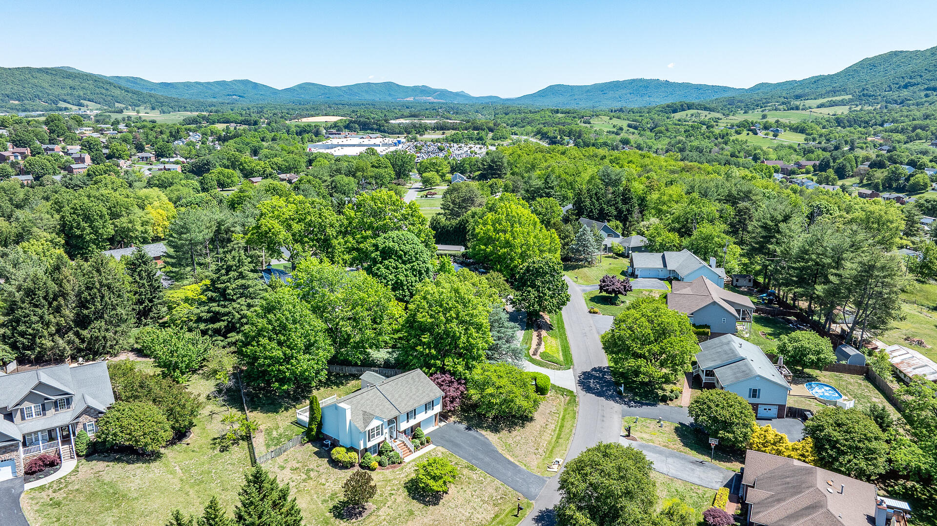 5443 Setter Road Roanoke, VA 24012 - Photo 4 of 42 an aerial view of green landscape with trees houses and mountain view