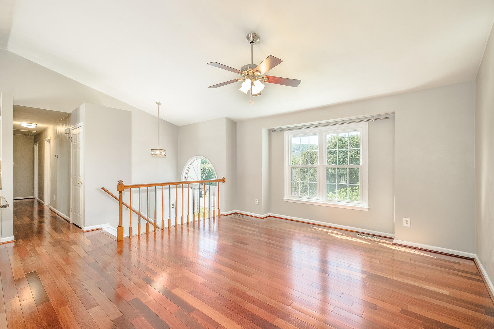 5443 Setter Road Roanoke, VA 24012 - Photo 8 of 42 an empty room with wooden floor fan and windows