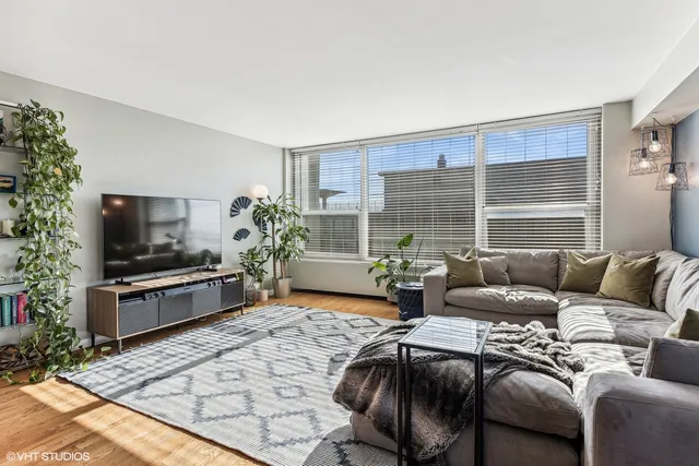 a kitchen with stainless steel appliances kitchen island wooden floors and white cabinets