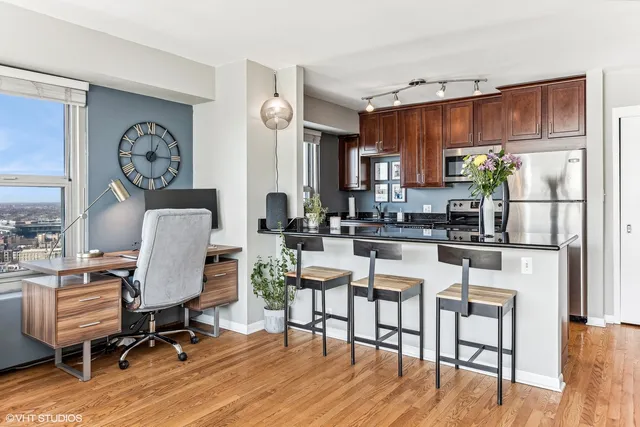 a patio with a table and chairs and potted plants