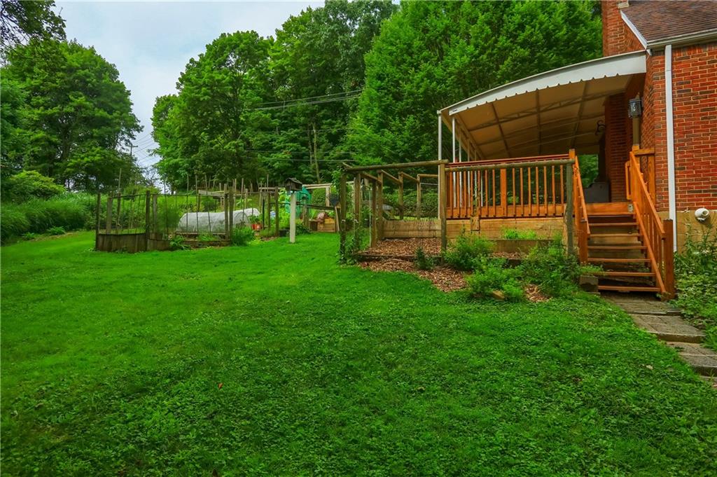 836 Harmony Road Pittsburgh, PA 15237 - Photo 7 of 46 a view of a backyard with plants and wooden fence