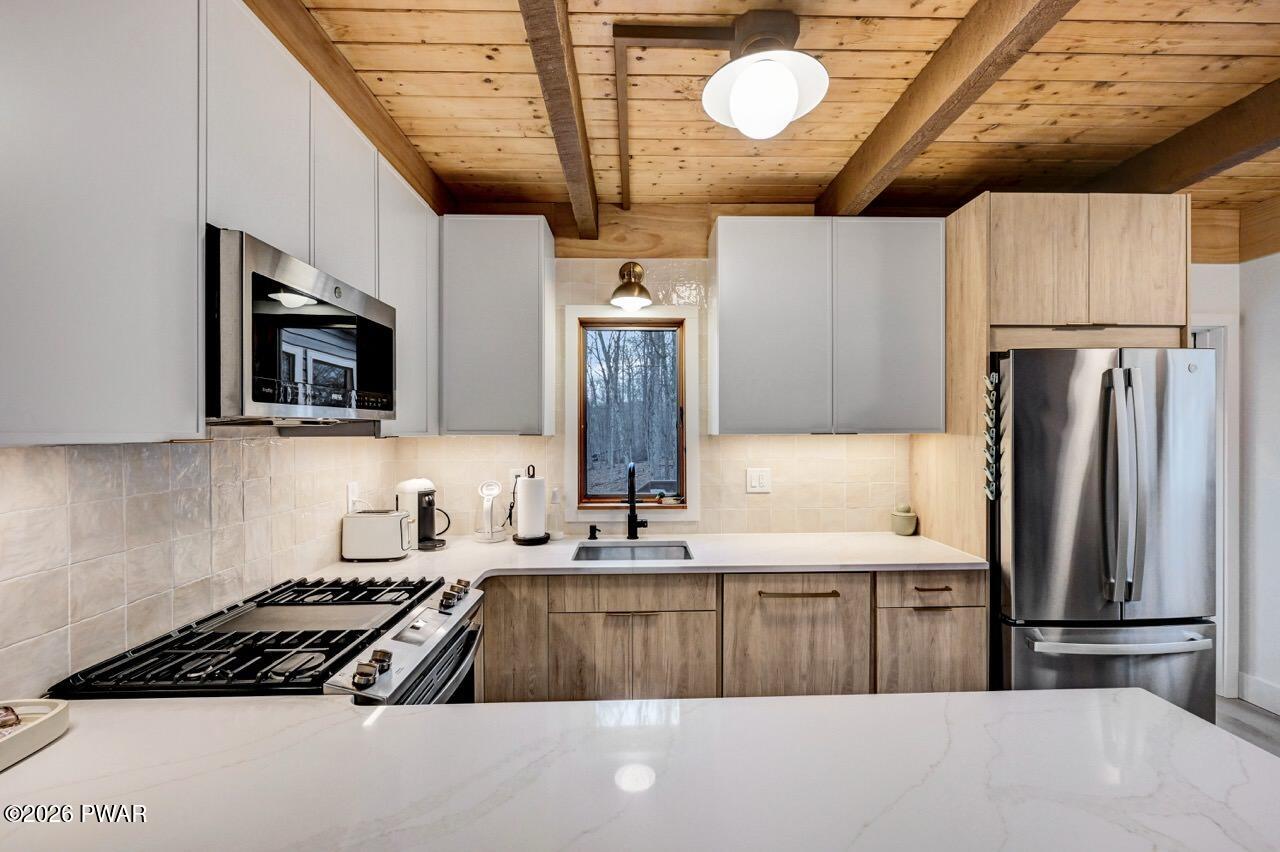 258 Lakeview Road Lackawaxen, PA 18435 - Photo 17 of 119 a kitchen with stainless steel appliances a refrigerator a stove a sink and a microwave