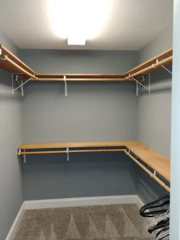 a room with a sink cabinets and a window