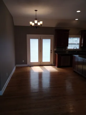 a view of a livingroom with furniture window and wooden floor