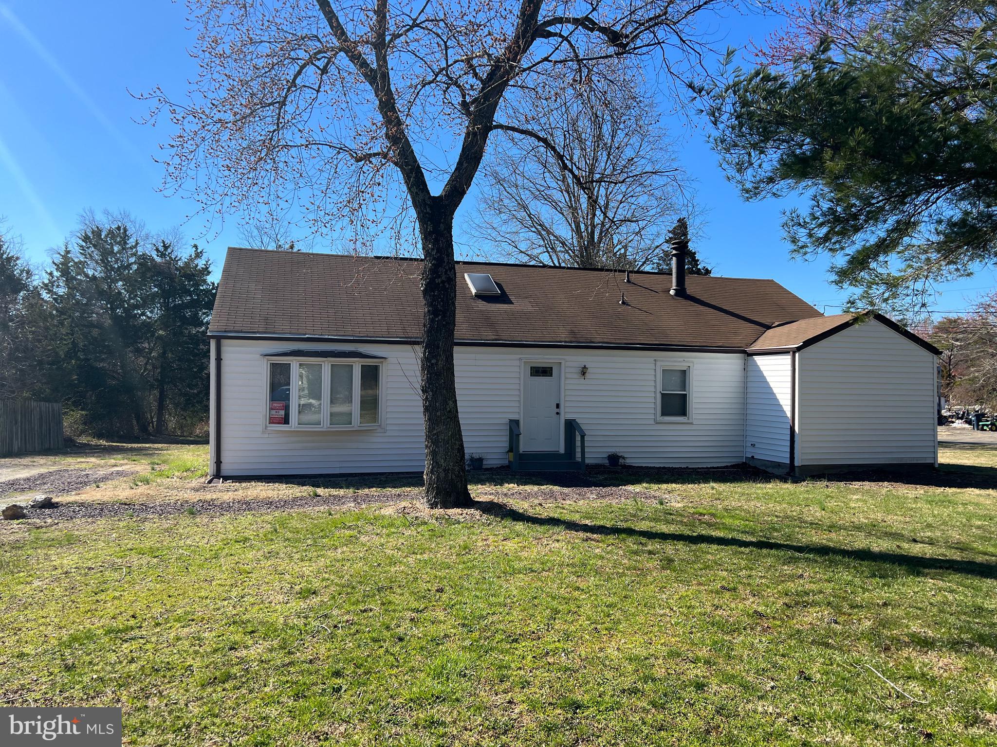 a house that has a tree in front of it