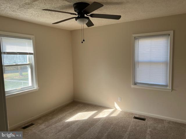 17207 Manning Drive Accokeek, MD 20607 - Photo 13 of 18 an empty room with a window and a fan