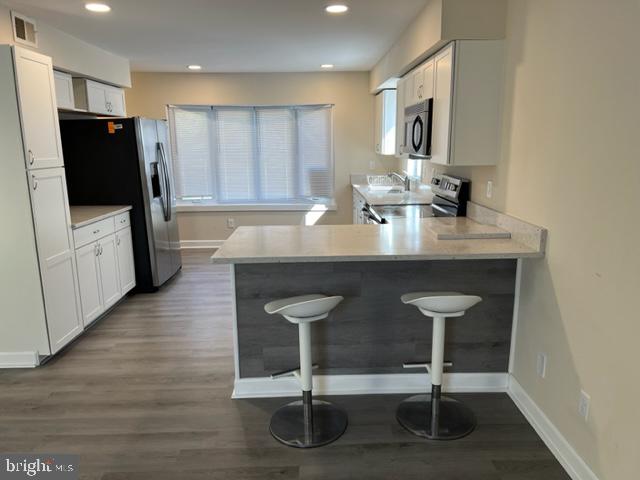 17207 Manning Drive Accokeek, MD 20607 - Photo 5 of 18 a kitchen with a table chairs refrigerator and microwave