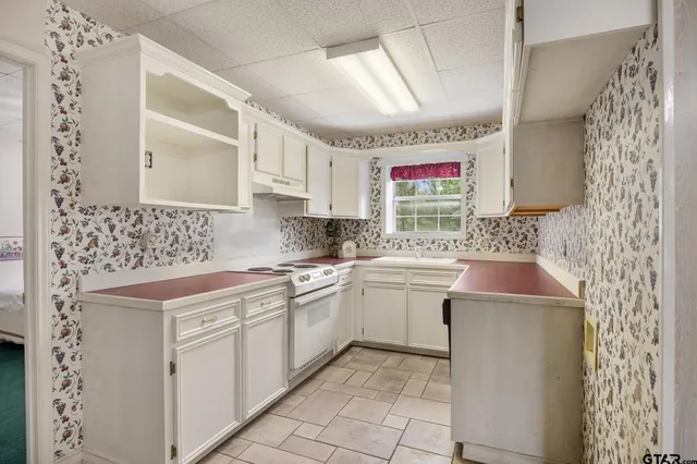 a kitchen with a sink stove and cabinets
